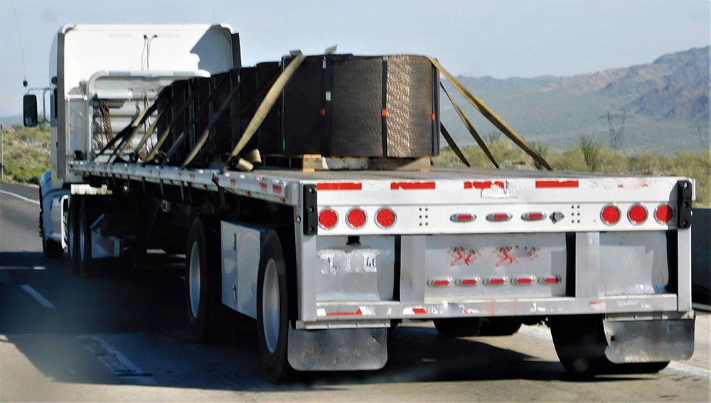 Loaded truck with construction materials on the road