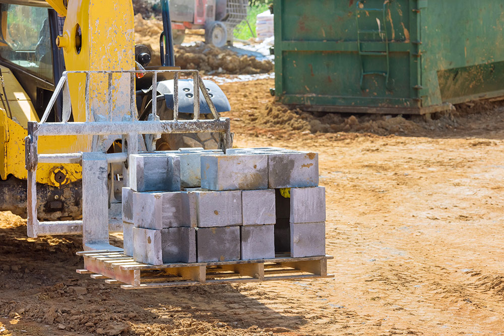 Forklift With A Boom Moving Cement Blocks