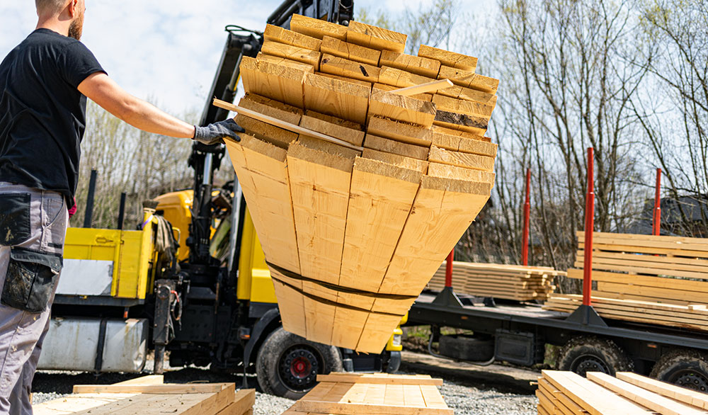 Unloading Wooden Beams From Truck On Construction